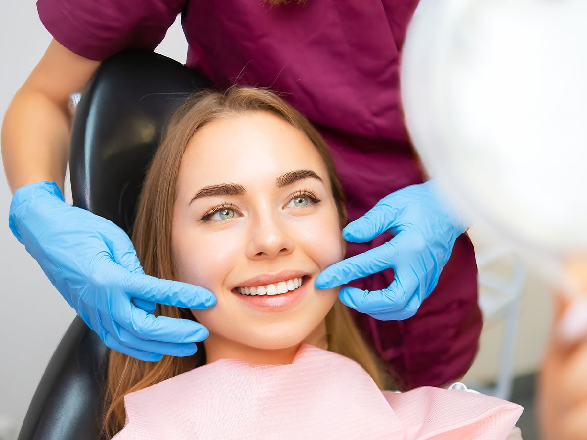 patient from bradstowe dental practice, woking, surrey, viewing composite bonding results in mirror