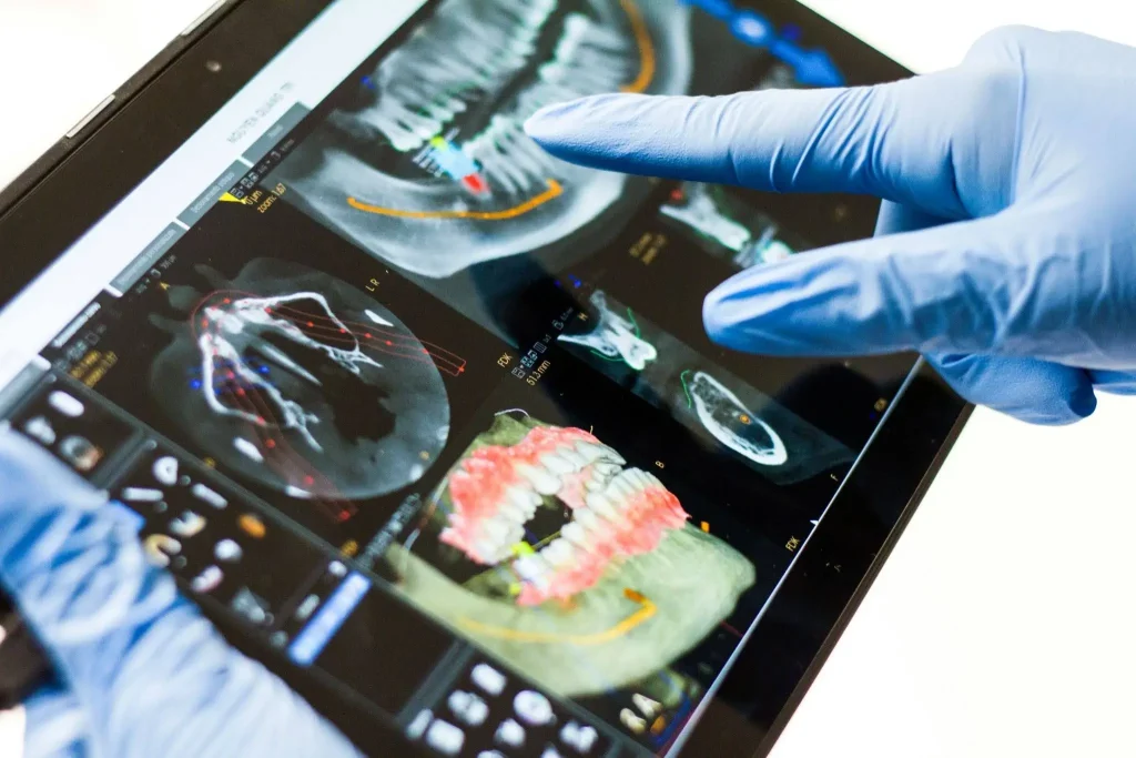 Dentist holding screen looking at teeth